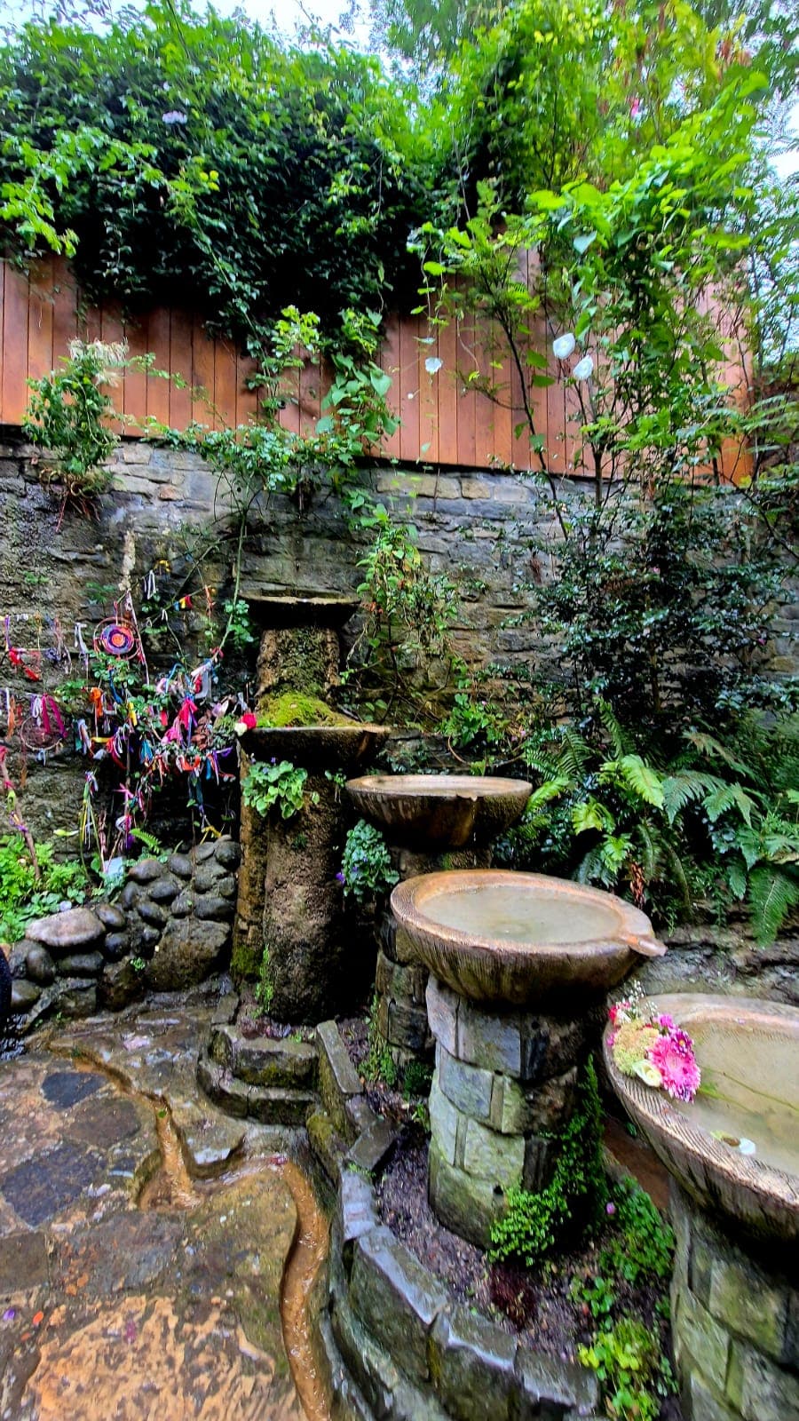 Mystical garden with ancient stone fountains and prayer offerings